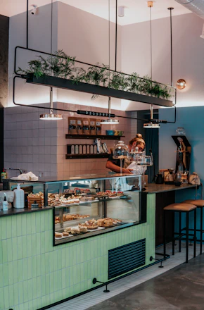 man in black t-shirt standing in front of counter