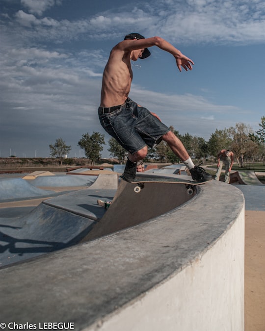 man in black shorts doing skateboard stunts on skateboard ramp during daytime in La Faute-sur-Mer France