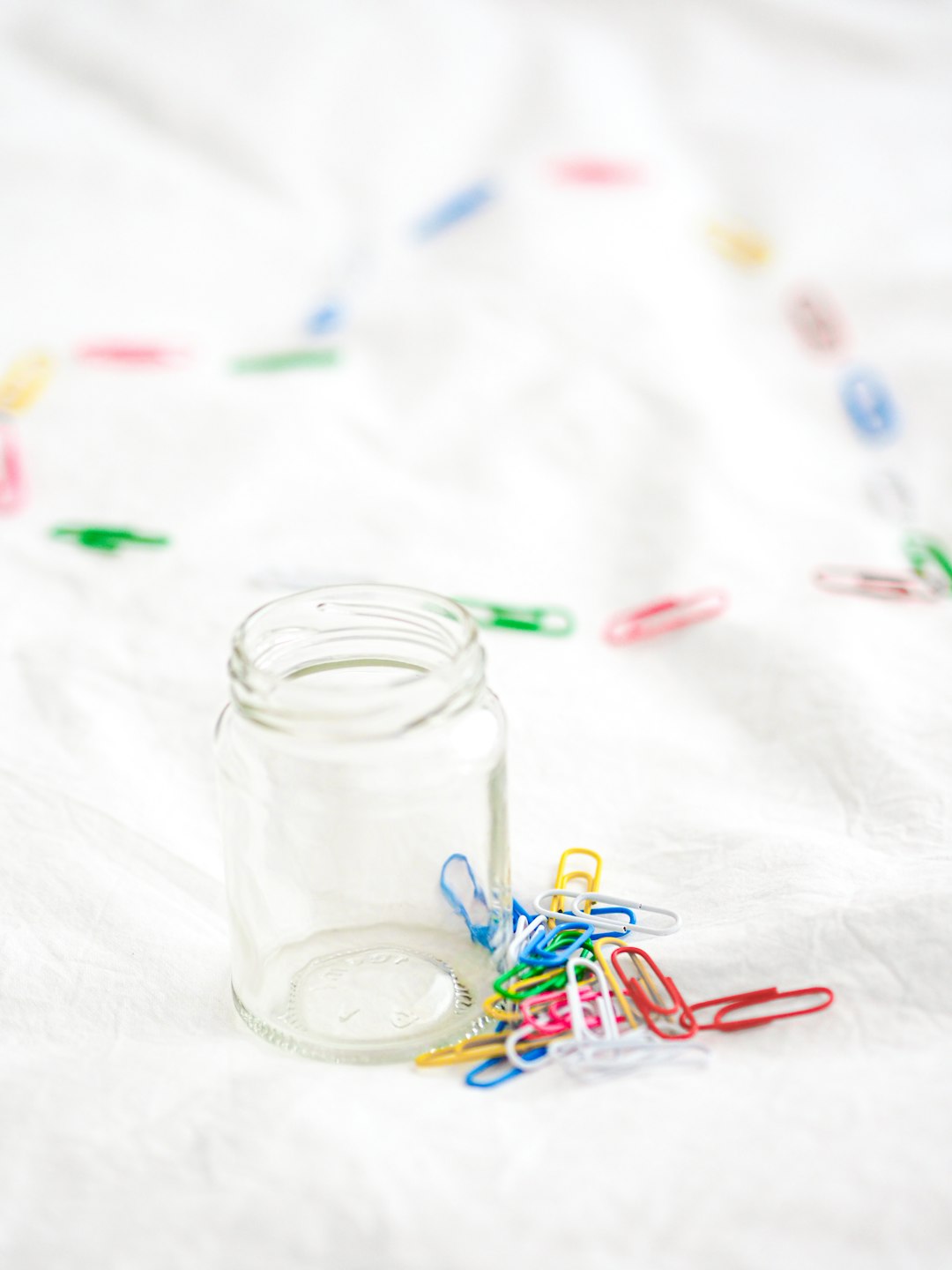 clear glass jar with white and red ribbon