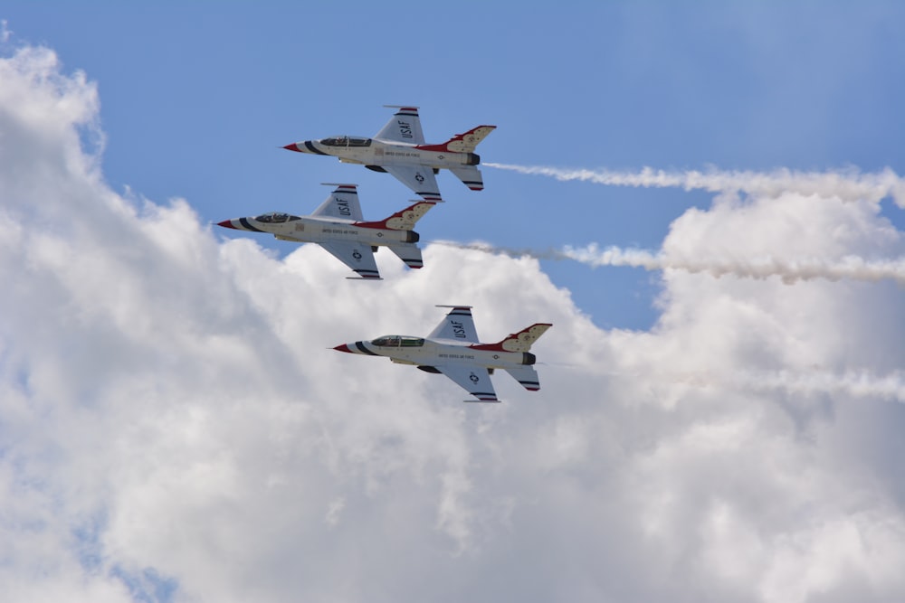 four fighter planes flying in the sky during daytime