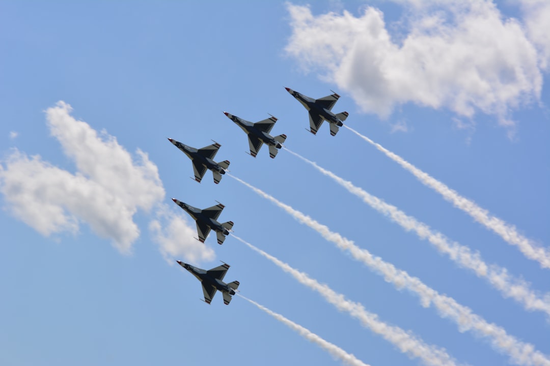 four fighter planes in mid air, Airplanes flying in formation at an air show
