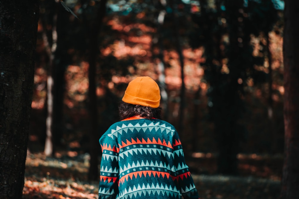 a person walking through a forest with trees