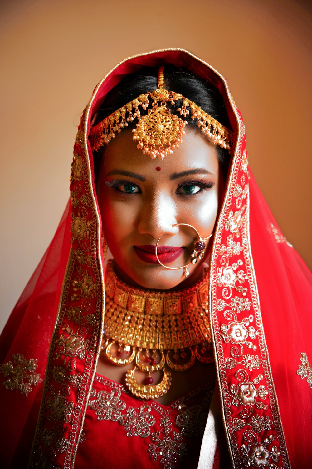 woman in red and gold hijab