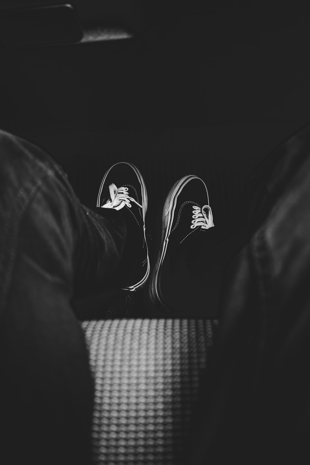 person wearing black and white sneakers