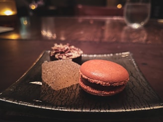 A close-up of a comforting dessert with subtle brown and cream colors, softly lit to highlight its creamy texture on a minimalist plate.