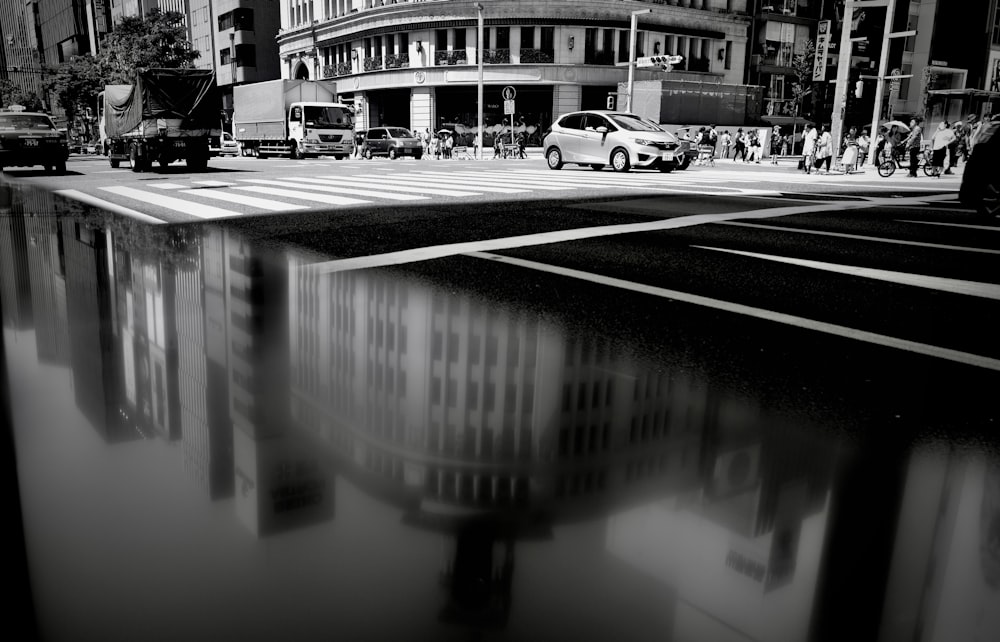 grayscale photo of cars on road