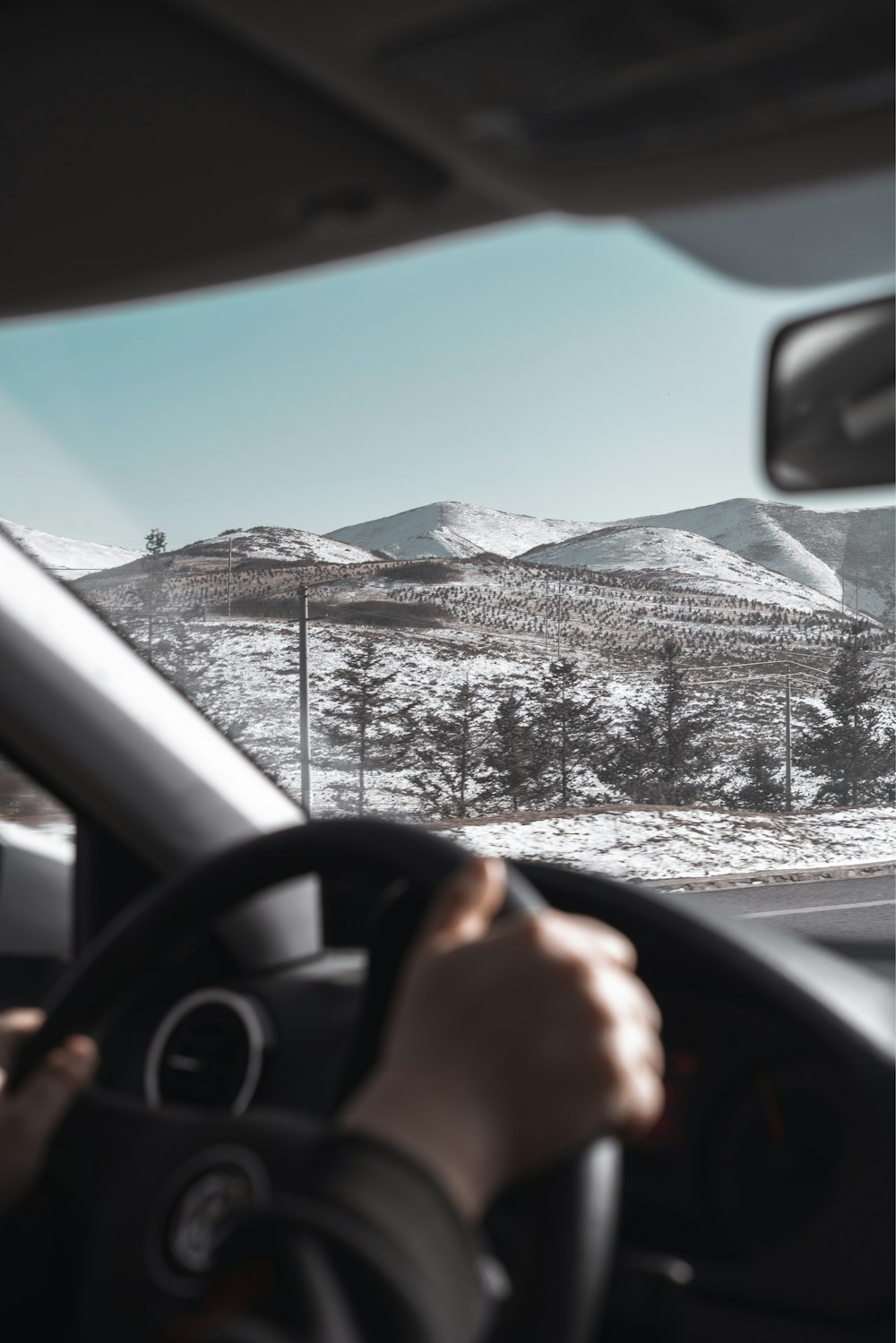 person driving car on road during daytime