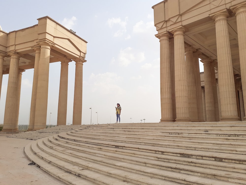 man and woman walking on gray concrete pathway during daytime