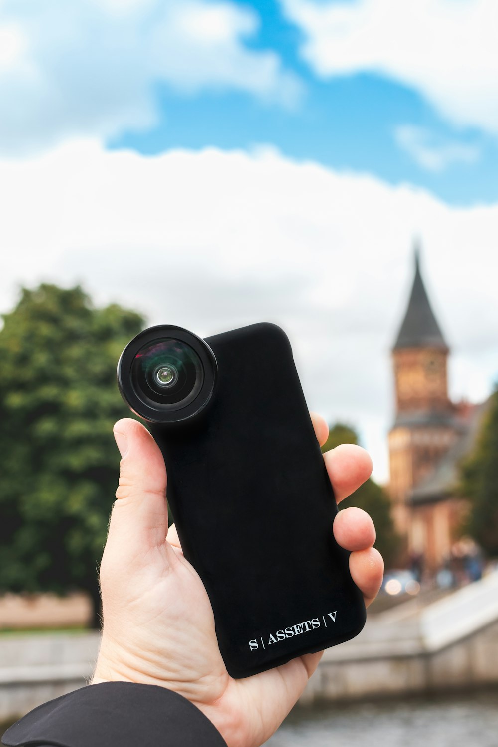 person holding black camera lens