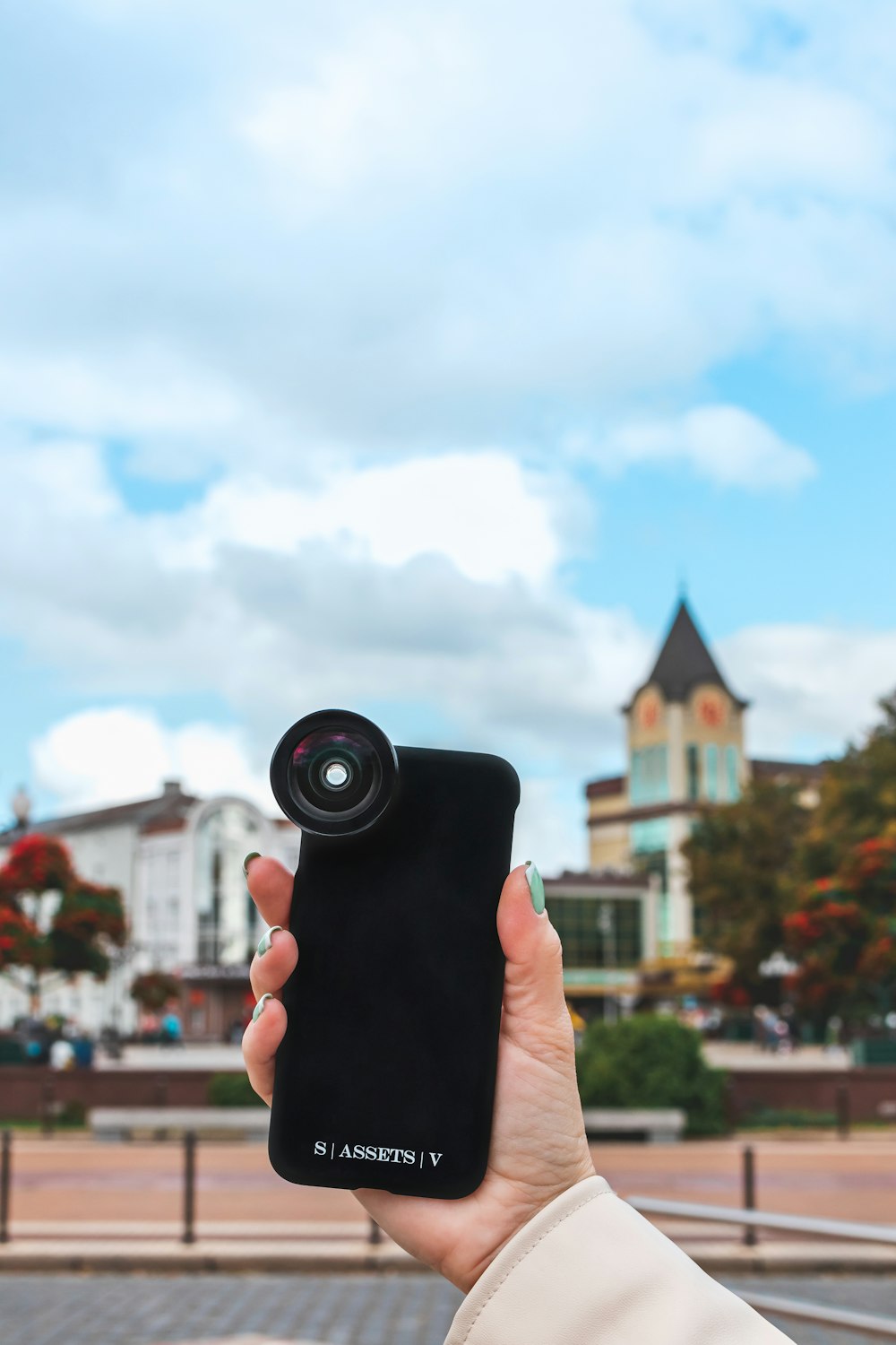 person holding black camera during daytime