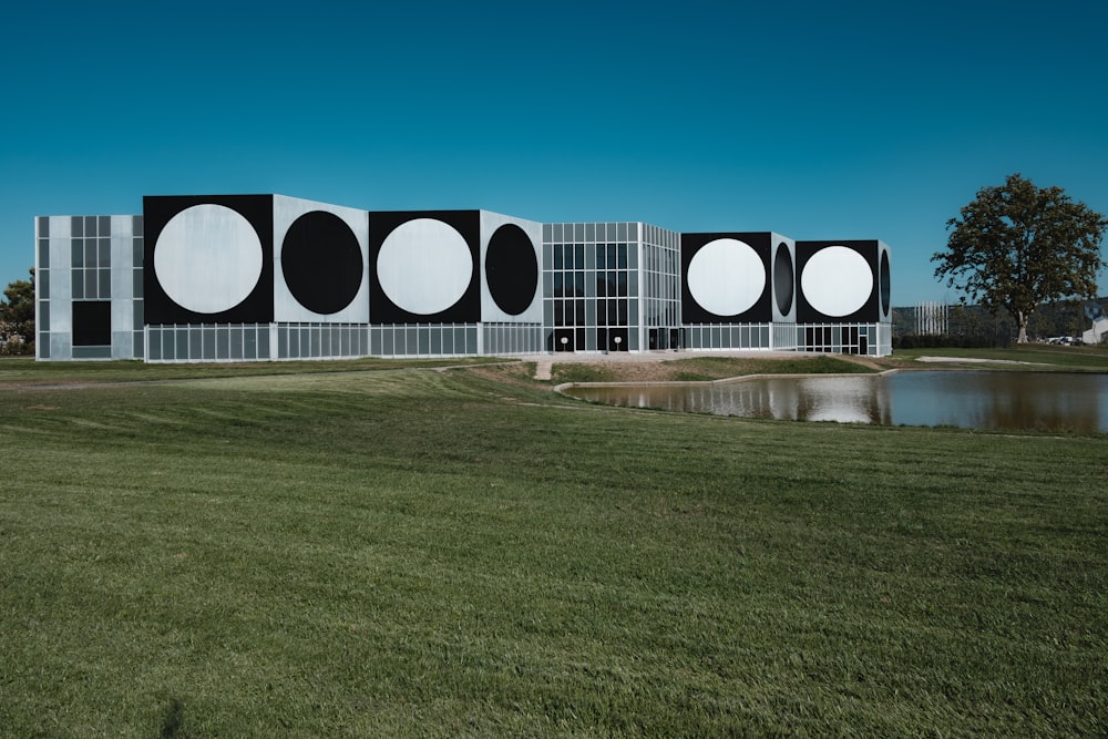 white and black tunnel on green grass field under blue sky during daytime