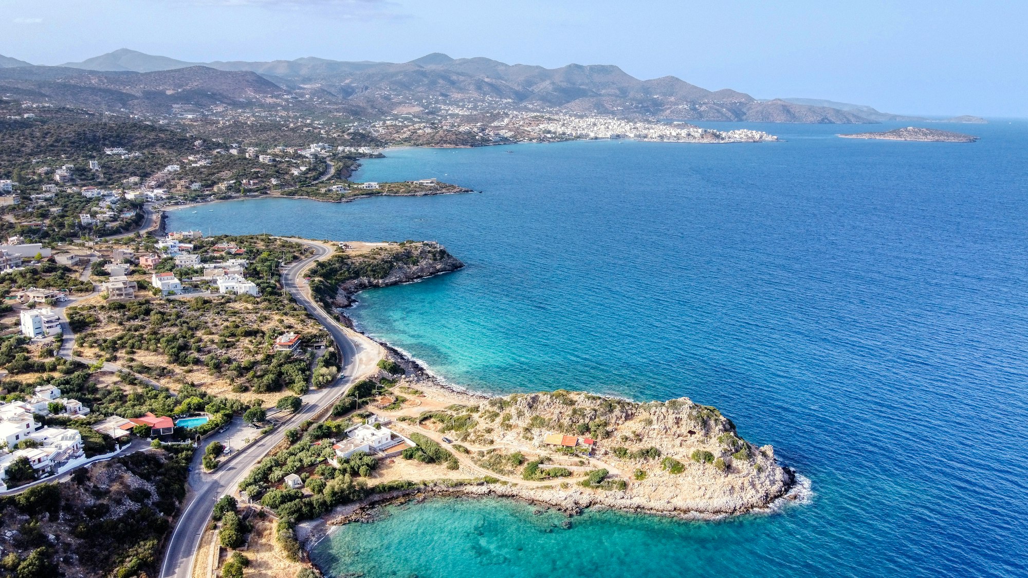 Coast Line of Aghios Nikolaos taken from the East side. the central point of the photo is Thief's Cave.It is said that  A thief used to live there at old times.
Nice quiet small beach at 10 minutes east from Agios Nikolaos