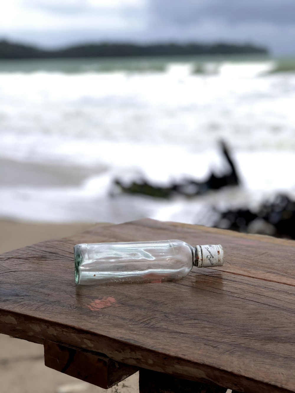 clear glass condiment shaker on brown wooden table