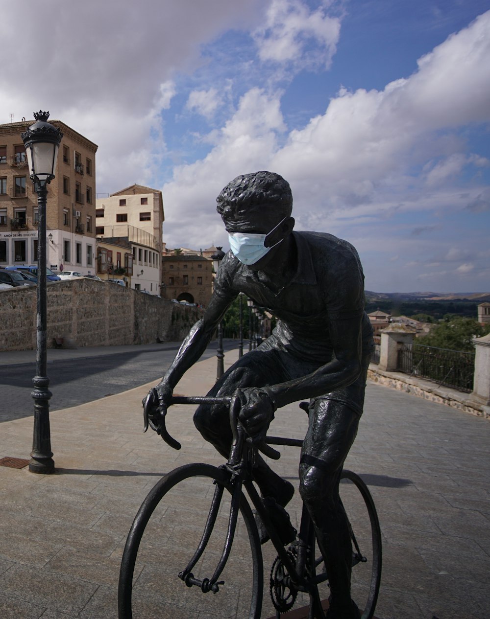 man in black jacket riding bicycle on road during daytime