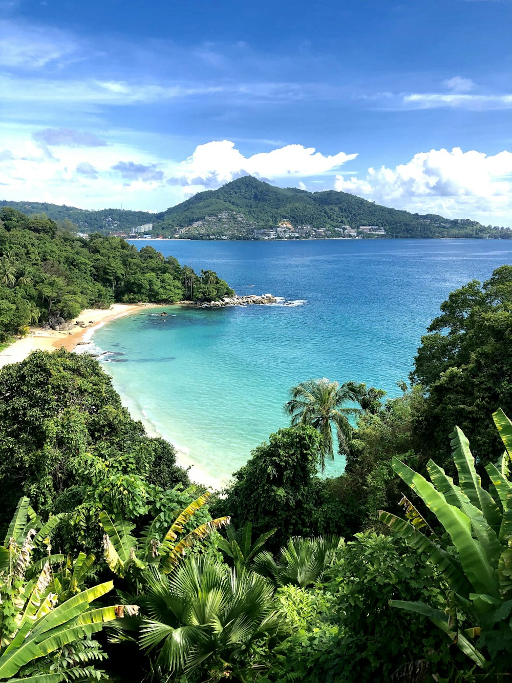 a view of a tropical beach from a hill