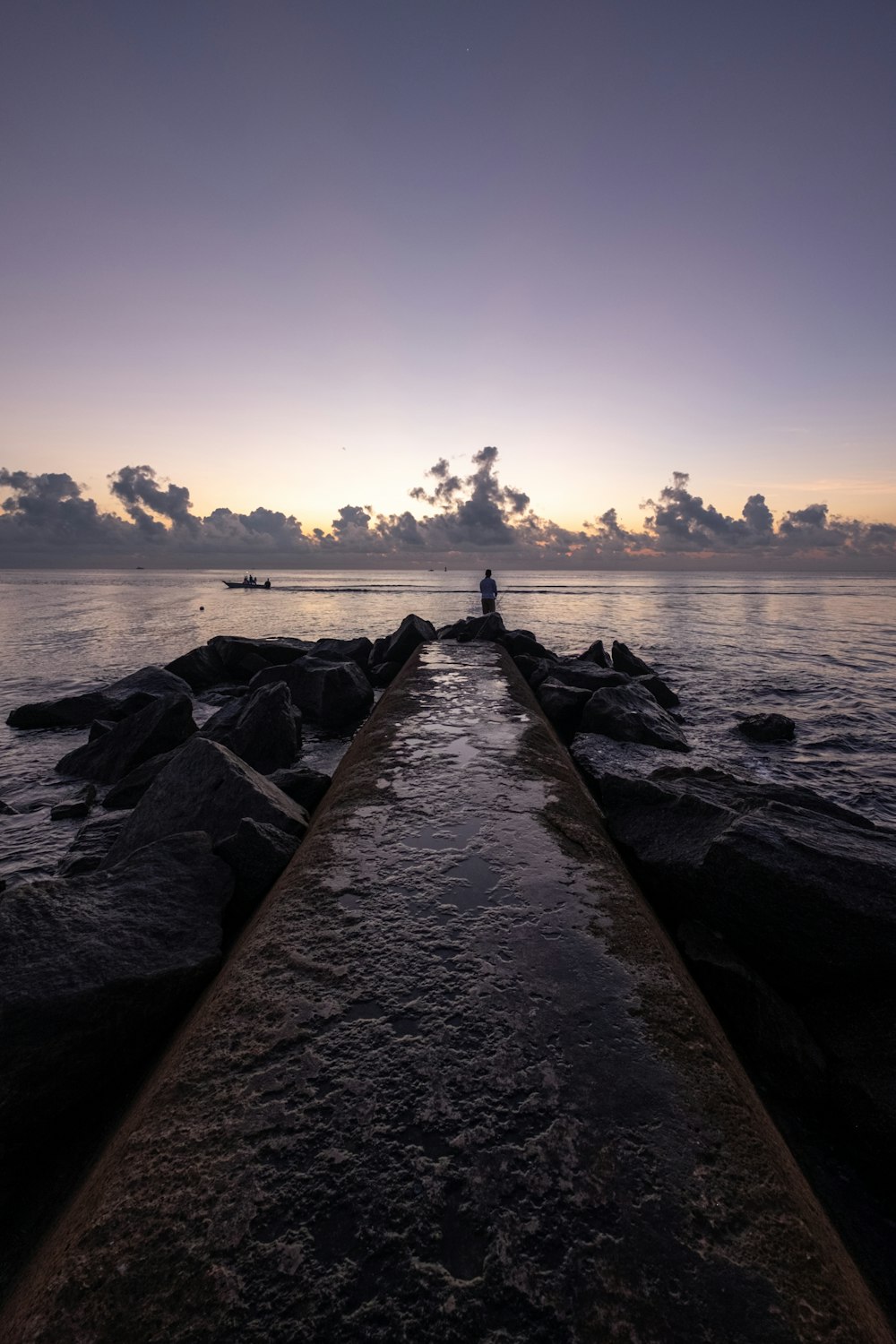 gray concrete dock near body of water during daytime