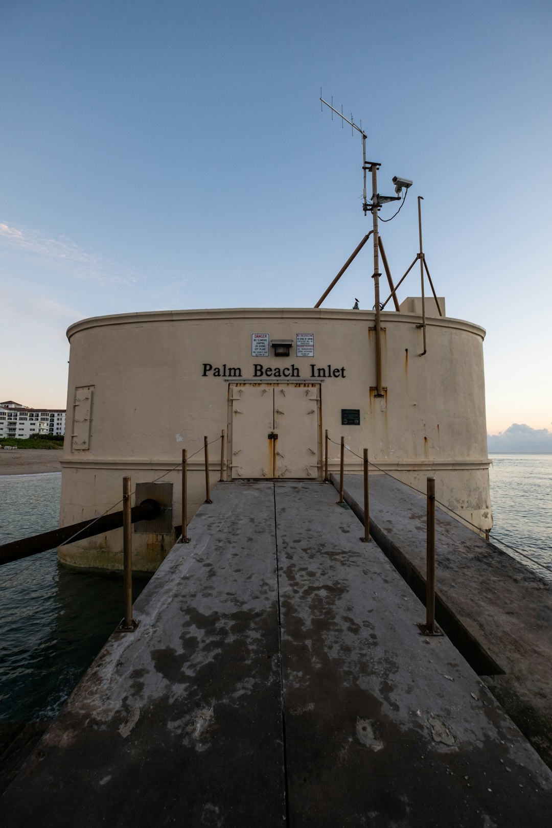 white and brown concrete building near body of water during daytime