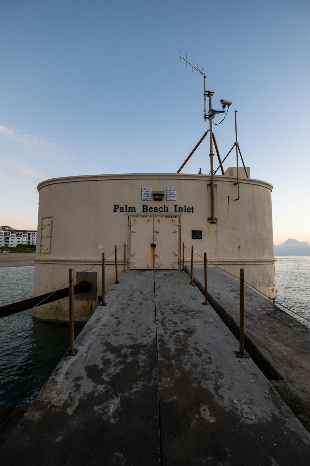 white and brown concrete building near body of water during daytime