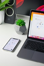 silver iphone 6 beside macbook pro