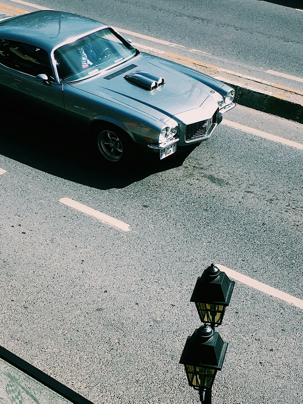 person in black jacket standing beside black car during daytime