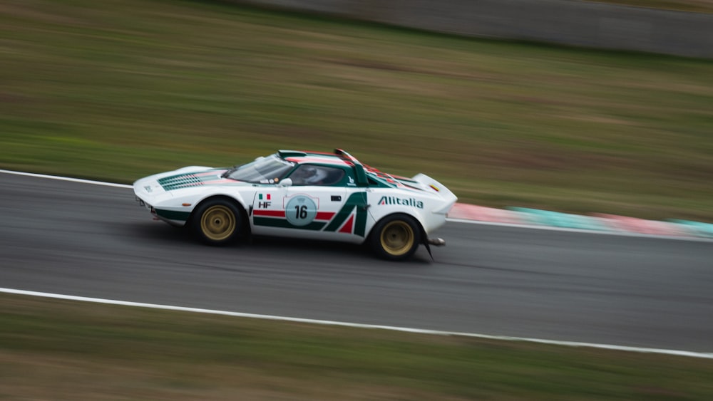 white and red racing car on track