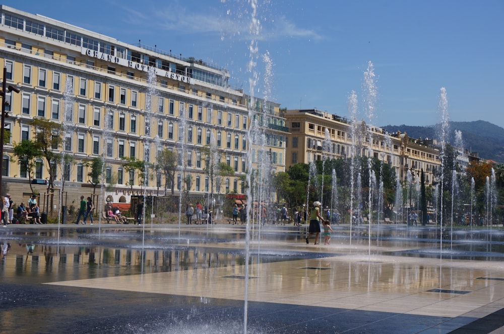 water fountain in front of beige concrete building