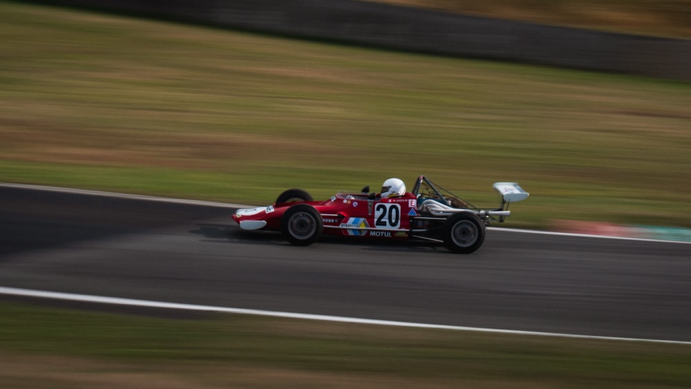 red and black f 1 car on road