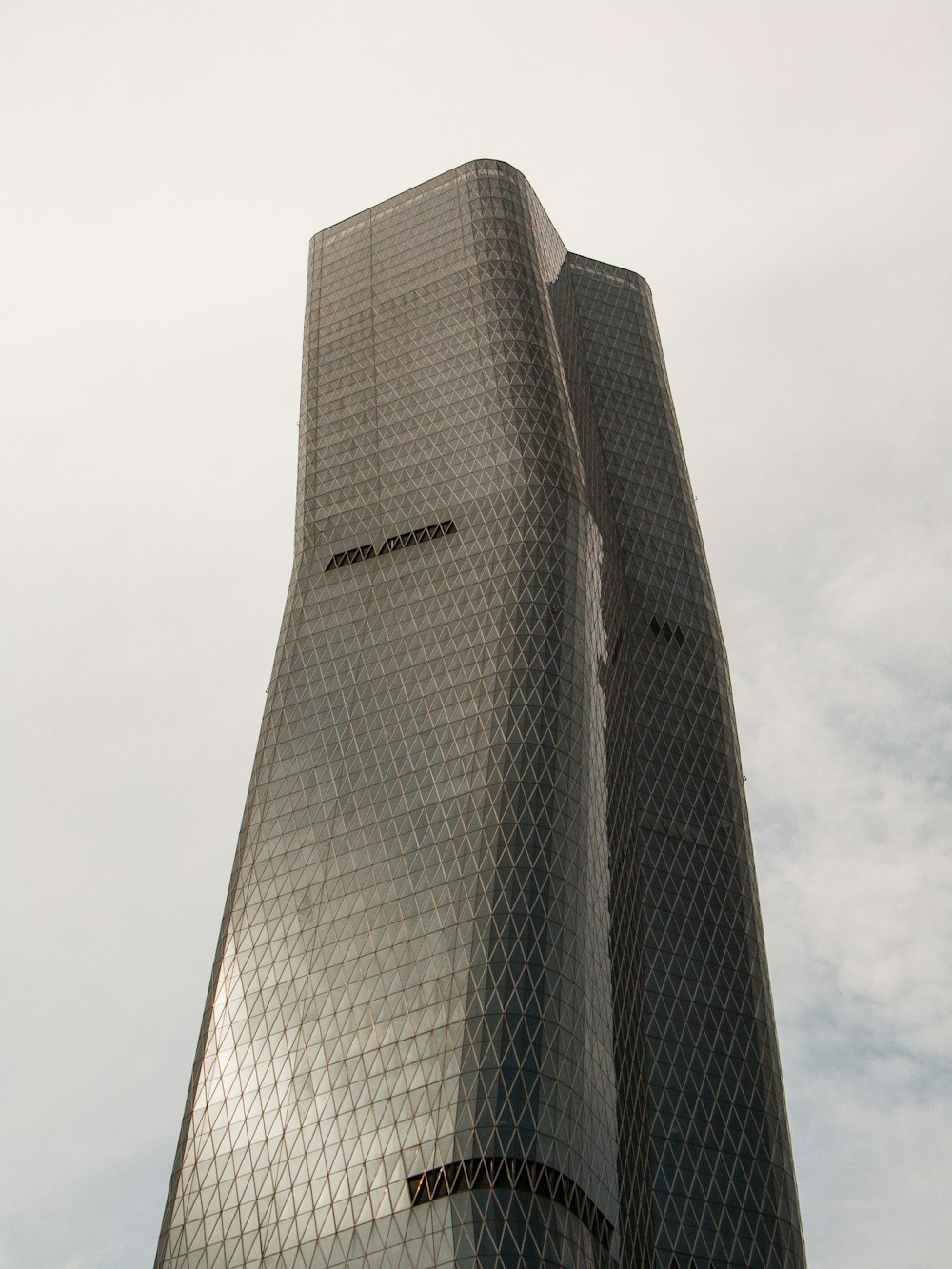 gray high rise building under white clouds during daytime