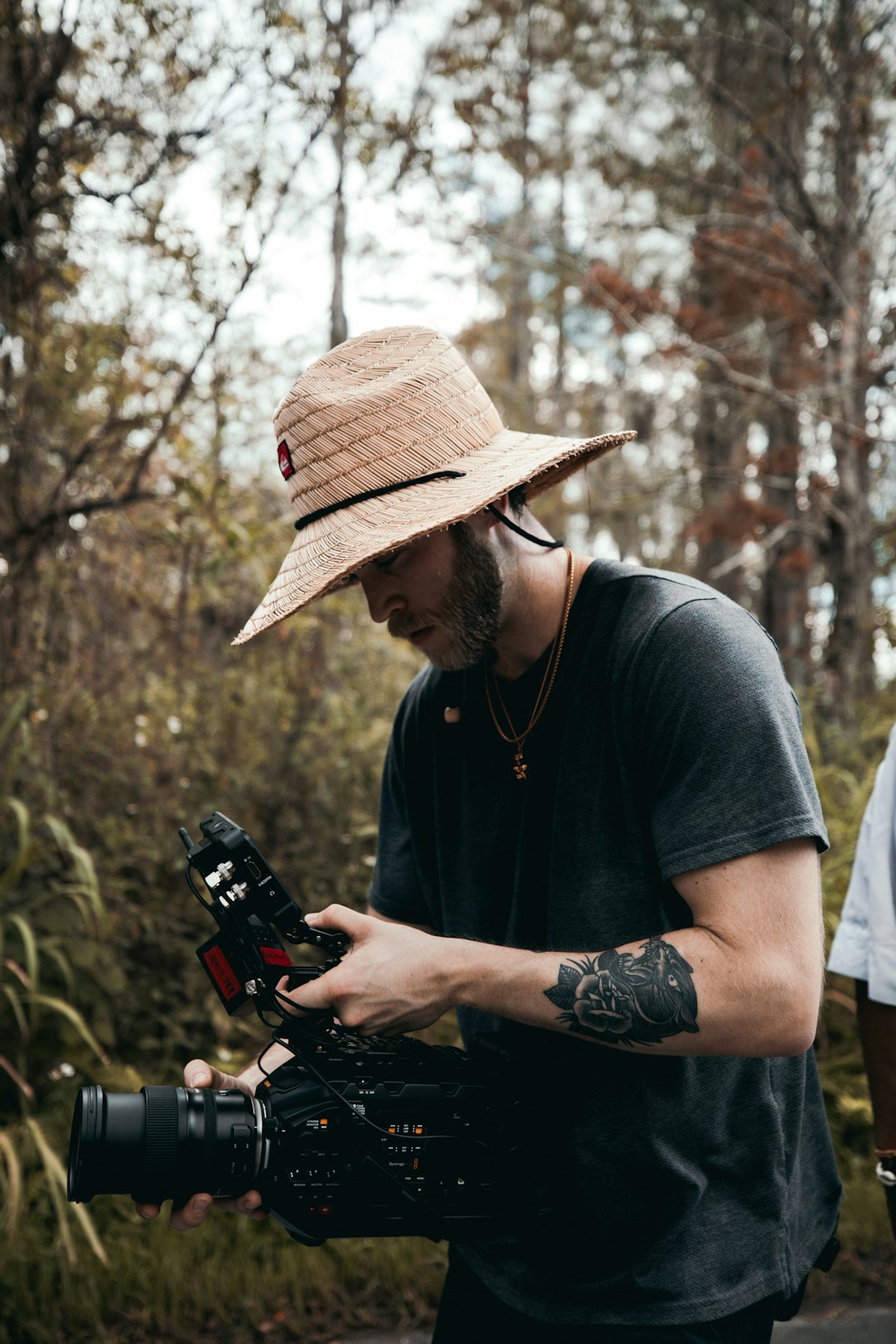 man in black crew neck t-shirt holding black and orange toy gun