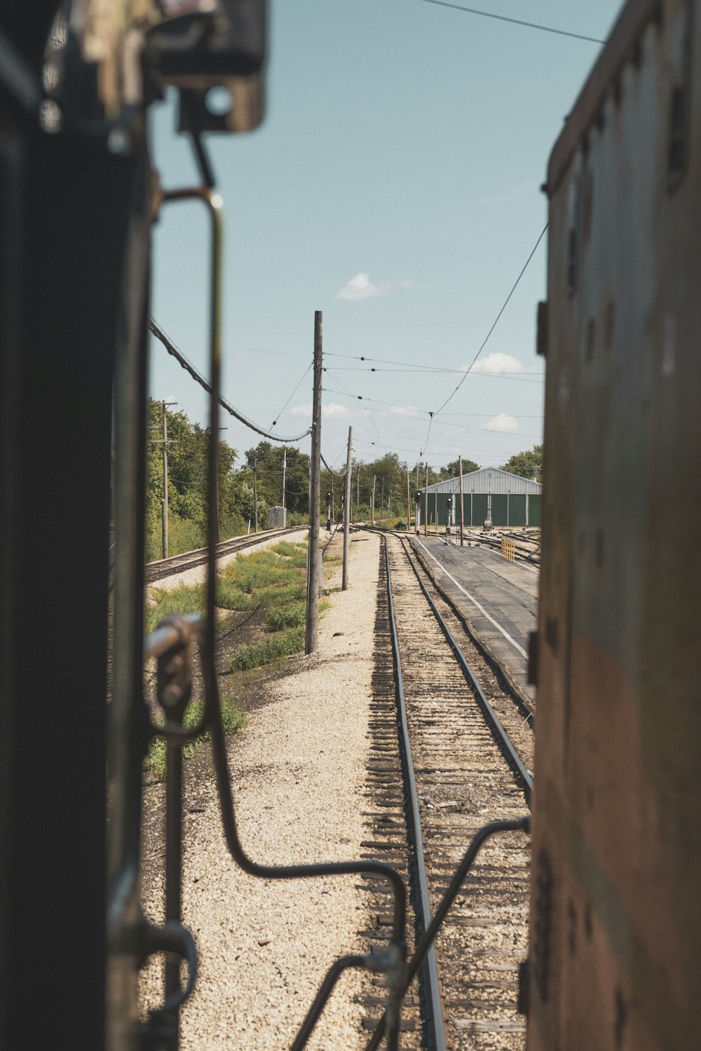 train rail near body of water during daytime