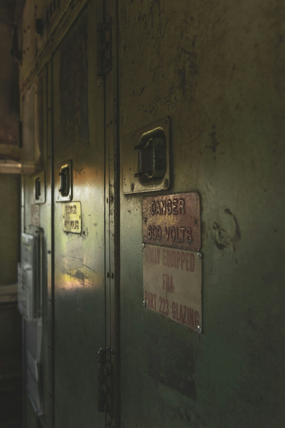 green wooden door with white and red label