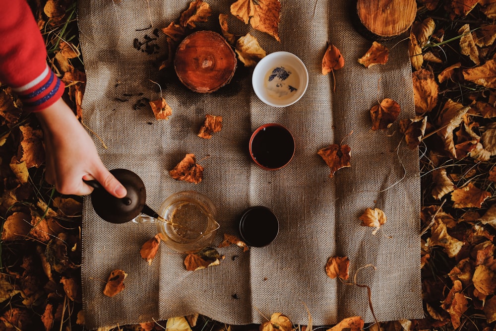 person pouring coffee on white ceramic mug