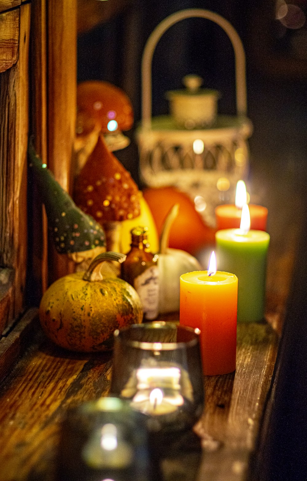 orange pillar candles on brown wooden table