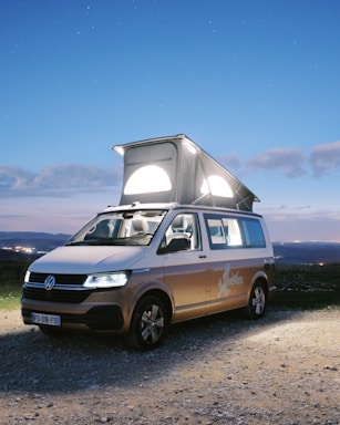 brown and white van on green grass field during daytime