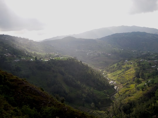 green mountains under white sky during daytime in Sindhupalchok Nepal