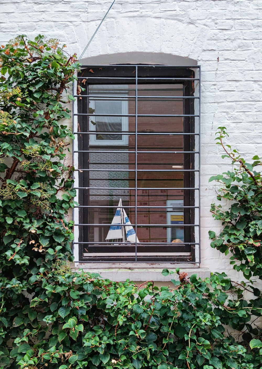 black metal window frame on white concrete wall