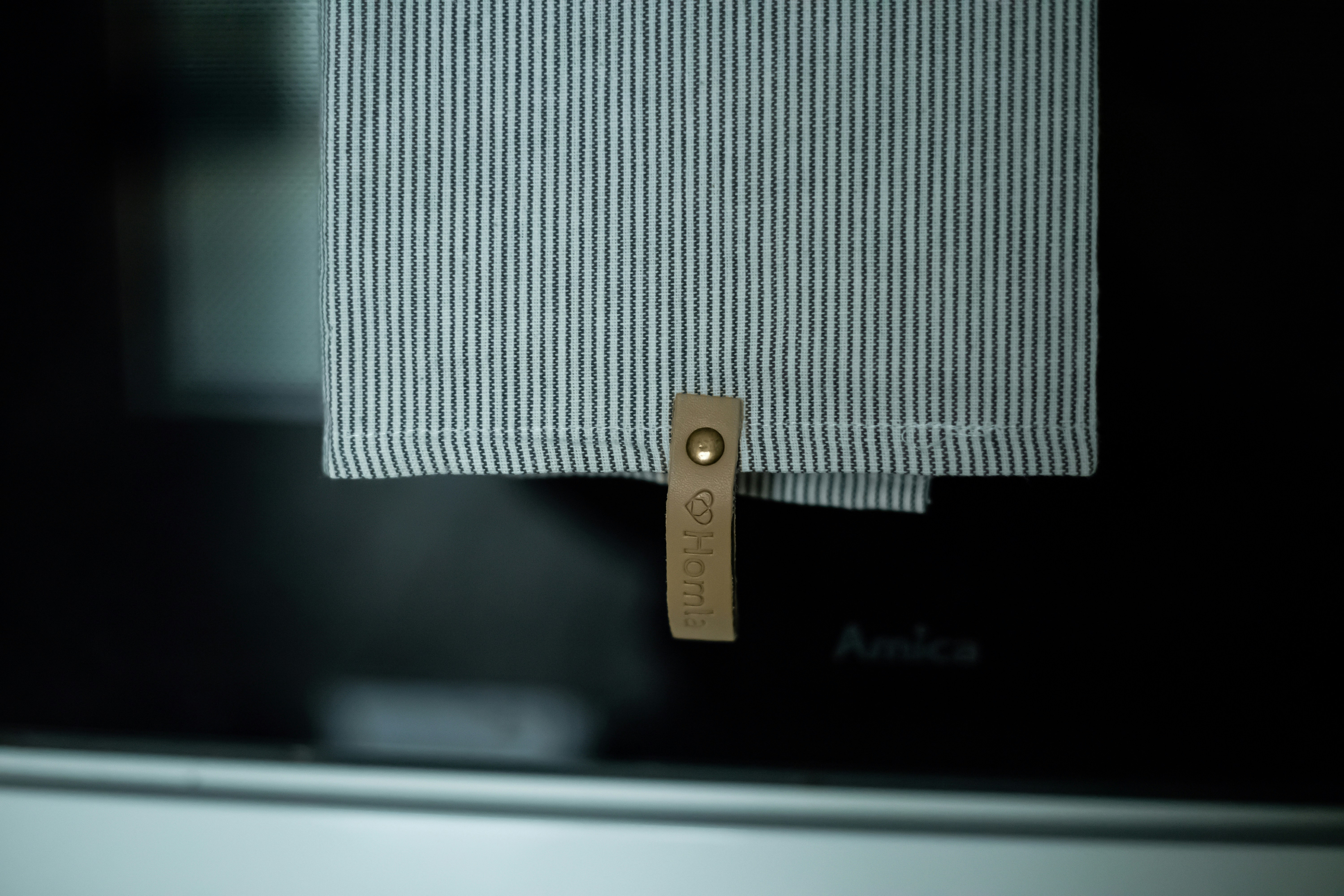 a stylish dishwasher curtain hack using a magnetic rod and striped fabric - renter-friendly hacks
