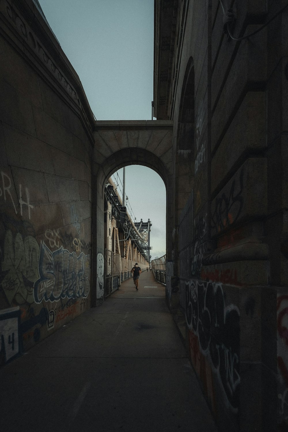 gray concrete hallway with graffiti