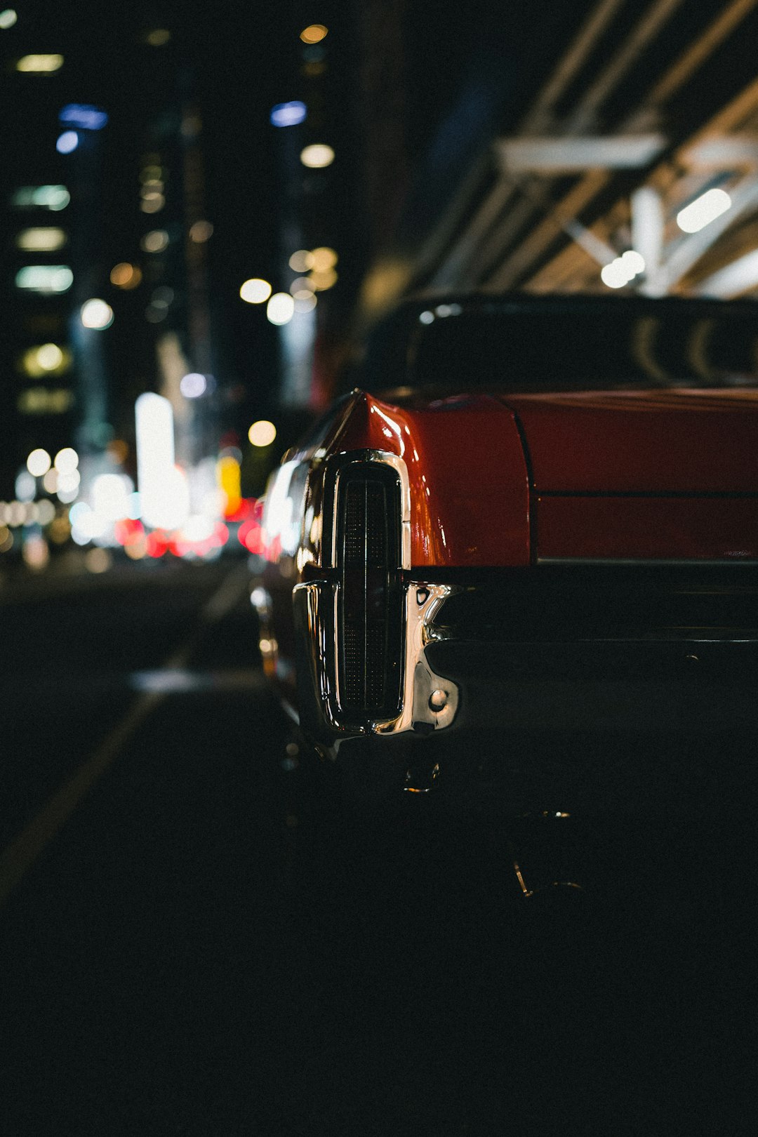 red car on the road during night time