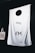 A large white fabric backdrop with minimalist black symbols hangs against a dark background. In the lower left corner, a beige tote bag with the text 'COLORADO' in black capital letters, split into three lines with a symbol replacing the letter 'I'.