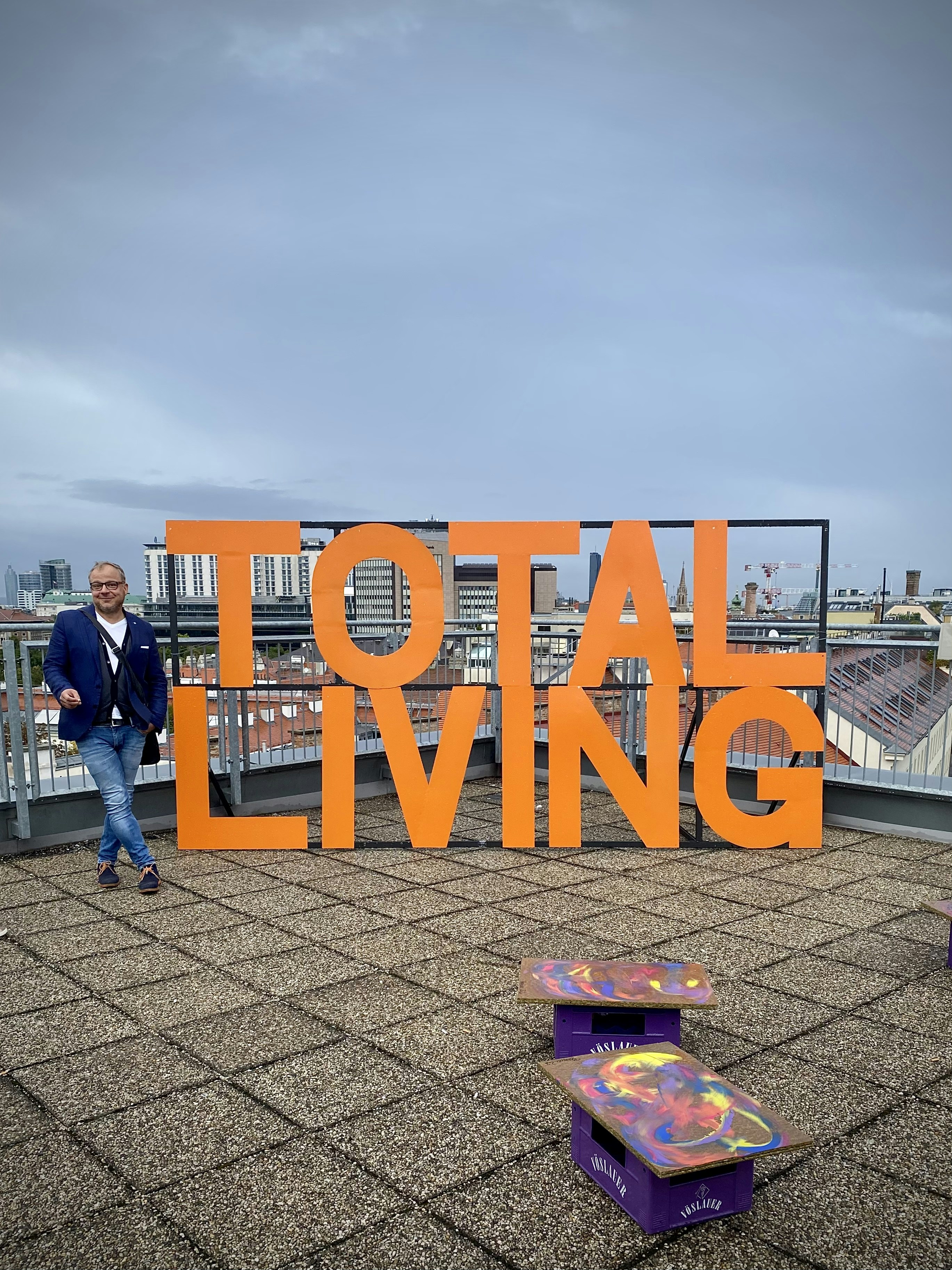 man in blue jacket standing beside orange and blue welcome to fabulous las vegas nevada signage