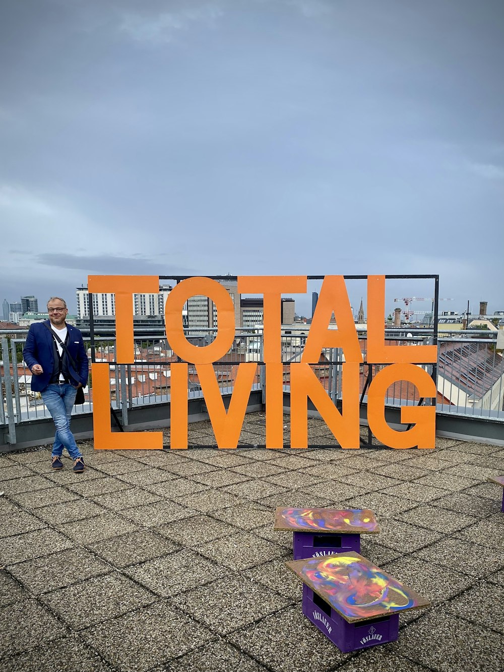 man in blue jacket standing beside orange and blue welcome to fabulous las vegas nevada signage