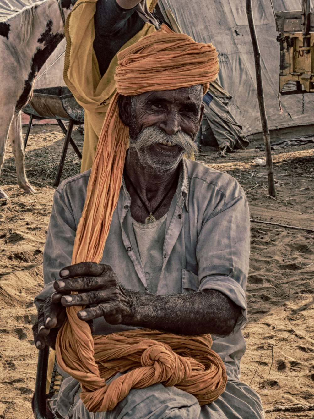 man in gray shirt wearing brown hat