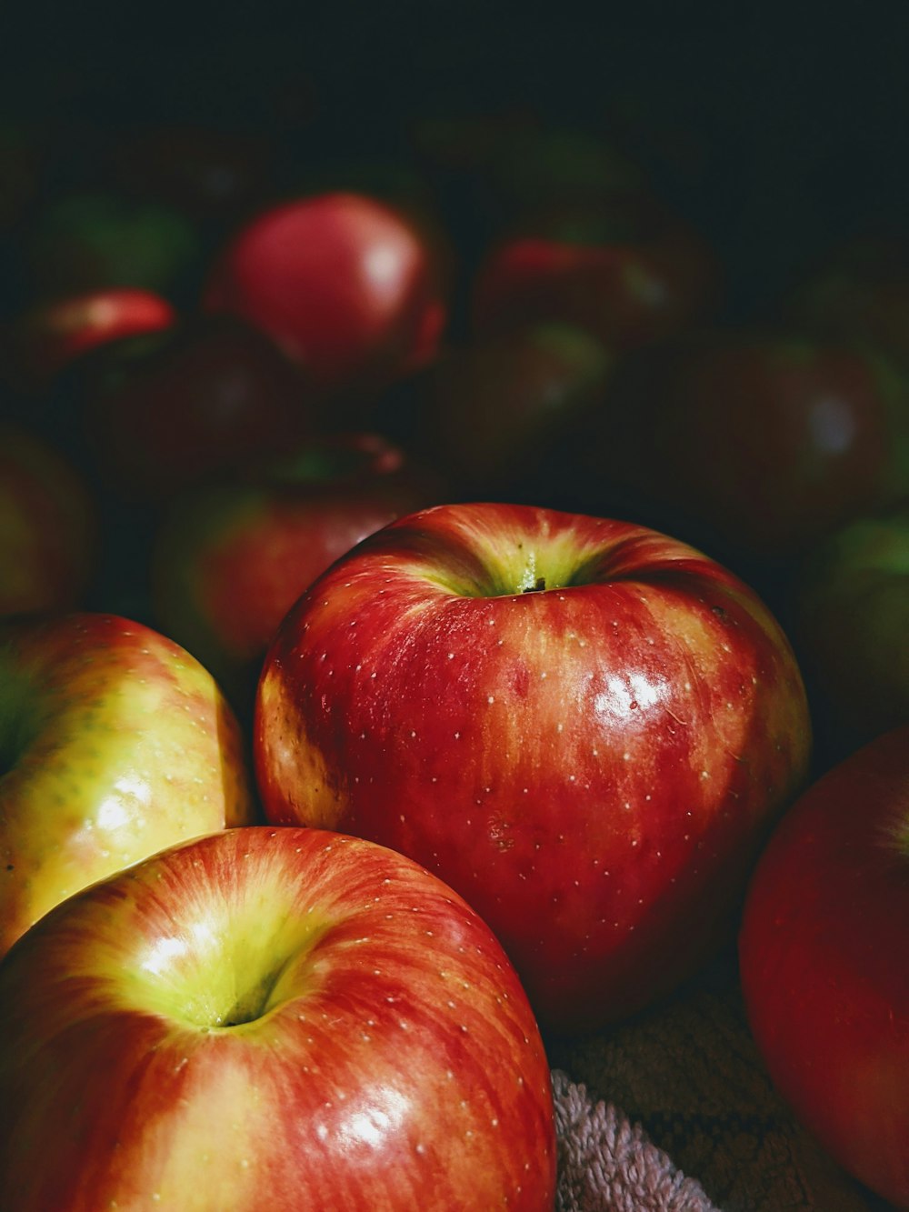 red and green apples on black surface