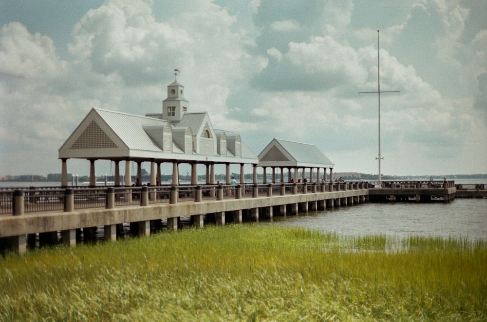 white and gray wooden house near body of water during daytime