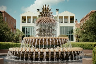 water fountain in front of white building