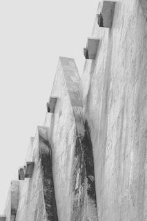 A retaining wall constructed on a sloped site, demonstrating durability and structural precision in an industrial setting.