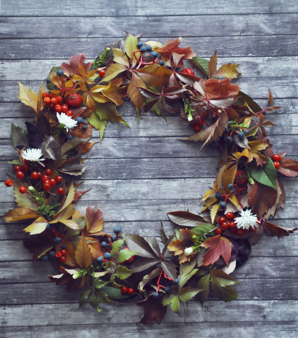 red and green leaves on wooden floor