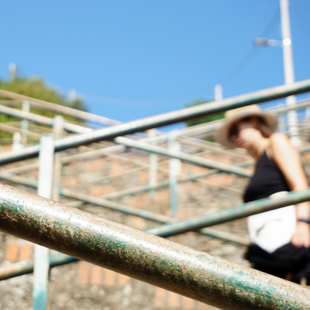 woman in black shirt standing on bridge during daytime