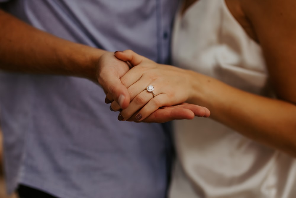 man in blue button up shirt wearing silver ring